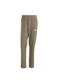 Adidas - Spodnie Multi Essentials Stretch. Kolor: beżowy. Materiał: materiał