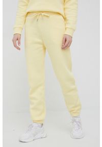 Peak Performance spodnie dresowe damskie kolor żółty gładkie. Kolor: żółty. Materiał: dresówka. Wzór: gładki
