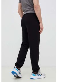 Fila spodnie dresowe kolor czarny gładkie. Kolor: czarny. Materiał: dresówka. Wzór: gładki #4