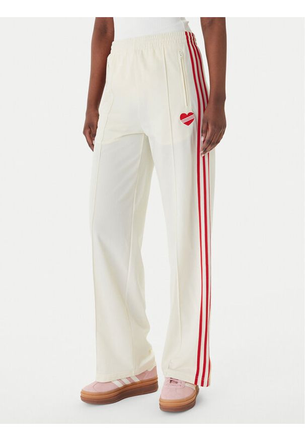 Adidas - adidas Spodnie dresowe Firebird KQ8056 Beżowy Loose Fit. Kolor: beżowy. Materiał: syntetyk