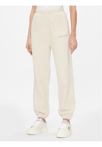 Tommy Jeans Spodnie dresowe Classics DW0DW17309 Beżowy Relaxed Fit. Kolor: beżowy. Materiał: bawełna #1