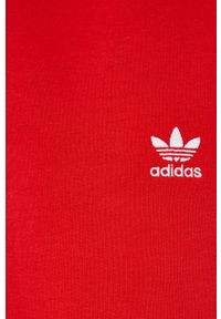 adidas Originals Spodnie damskie kolor czerwony gładkie. Stan: podwyższony. Kolor: czerwony. Materiał: dzianina, poliester, bawełna. Wzór: gładki