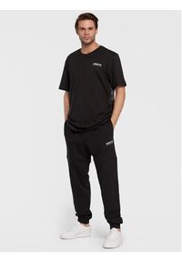 Adidas - adidas Spodnie dresowe Adventure HK5001 Czarny Regular Fit. Kolor: czarny. Materiał: dresówka, bawełna #3
