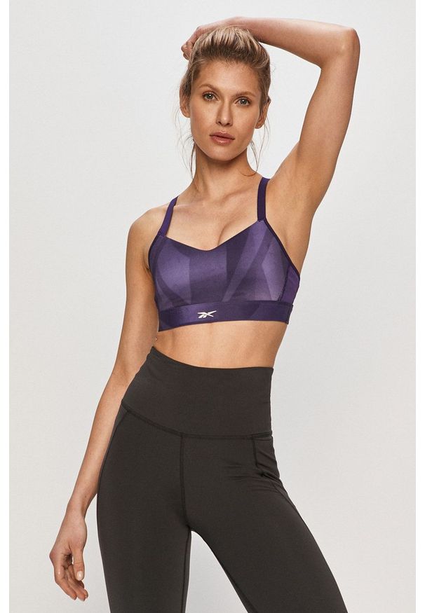 Reebok - Biustonosz sportowy. Kolor: fioletowy. Materiał: skóra. Rodzaj stanika: odpinane ramiączka
