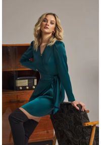 Sukienki.shop - Sukienka satynowa kopertowa mini z wiązaniem w talii zielona. Okazja: na ślub cywilny, na wesele, na imprezę. Kolor: zielony, czerwony. Materiał: satyna. Długość rękawa: długi rękaw. Typ sukienki: kopertowe. Styl: wizytowy. Długość: mini #6