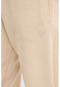 Guess - GUESS Beżowe damskie spodnie dresowe Primula. Kolor: beżowy. Materiał: dresówka