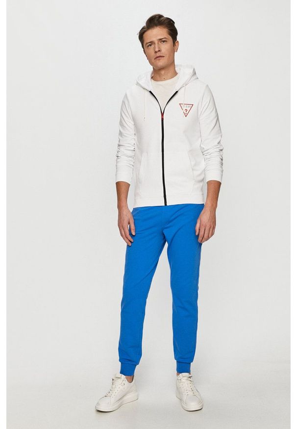 Guess - Spodnie. Kolor: niebieski. Materiał: dzianina. Wzór: gładki