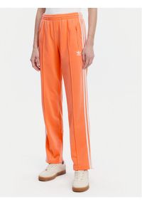 Adidas - adidas Spodnie dresowe adicolor Classics Firebird JC8286 Pomarańczowy Regular Fit. Kolor: pomarańczowy. Materiał: syntetyk #1