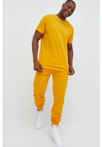 ARKK Copenhagen - Arkk Copenhagen spodnie dresowe bawełniane kolor żółty gładkie. Kolor: żółty. Materiał: bawełna, dresówka. Wzór: gładki #3