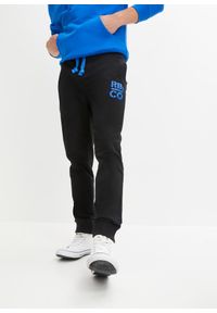 bonprix - Spodnie sportowe z kontrastowymi elementami. Kolor: czarny. Materiał: poliester, dresówka. Wzór: nadruk. Styl: sportowy #1