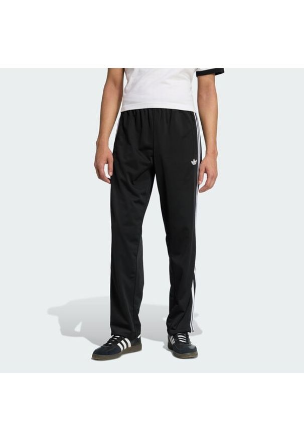 Adidas - adidas Spodnie dresowe Firebird KD8315 Czarny Loose Fit. Kolor: czarny. Materiał: syntetyk