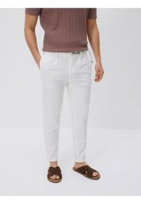 Reserved - Spodnie slim fit z paskiem - złamana biel. Materiał: dzianina, bawełna