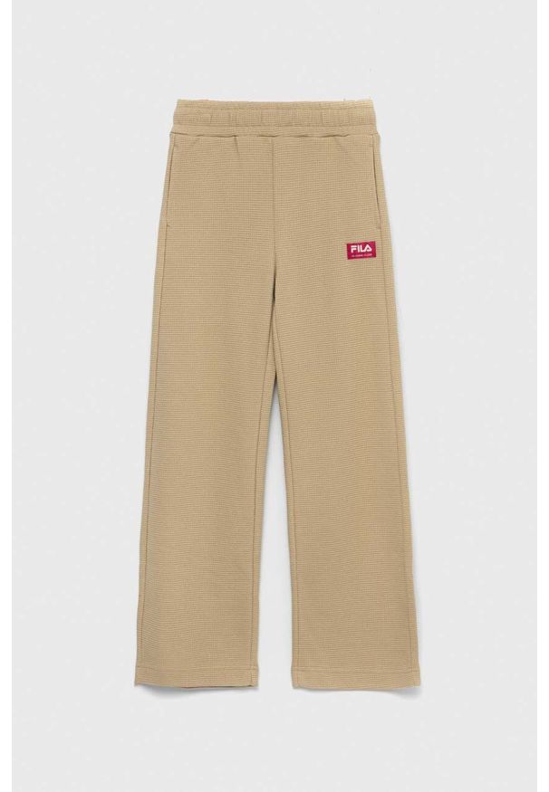 Fila spodnie dresowe dziecięce kolor beżowy gładkie. Stan: podwyższony. Kolor: beżowy. Materiał: dresówka. Wzór: gładki