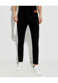 PALM ANGELS - Czarne jeansy z logo. Kolor: czarny. Długość: długie. Wzór: aplikacja, nadruk. Styl: klasyczny #1
