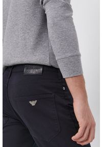 Emporio Armani spodnie męskie kolor granatowy dopasowane. Kolor: niebieski. Materiał: tkanina. Wzór: gładki #2