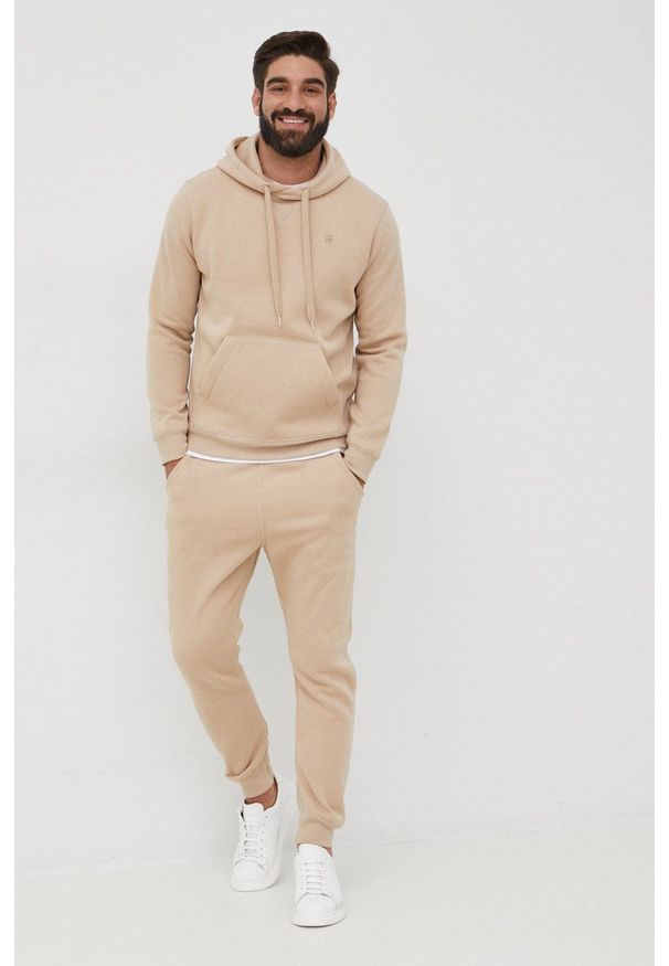 G-Star RAW - G-Star Raw spodnie męskie gładkie. Kolor: beżowy. Materiał: poliester. Wzór: gładki