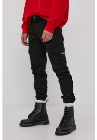 Tommy Jeans - Spodnie. Kolor: czarny. Materiał: tkanina. Wzór: gładki