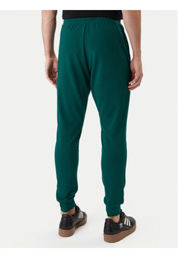 Adidas - adidas Spodnie dresowe Essentials Feel Cozy JE3858 Zielony Regular Fit. Kolor: zielony. Materiał: syntetyk, bawełna