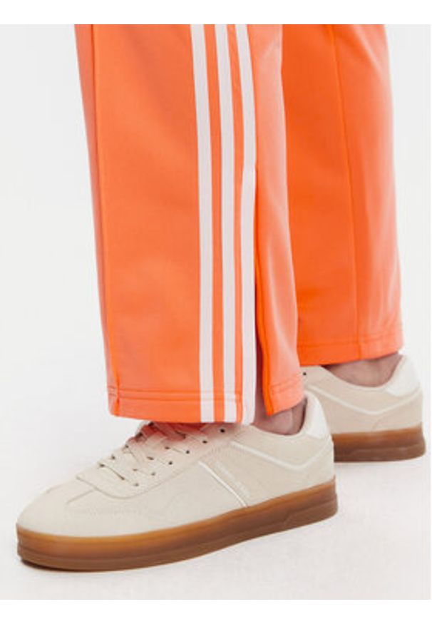 Adidas - adidas Spodnie dresowe adicolor Classics Firebird JC8286 Pomarańczowy Regular Fit. Kolor: pomarańczowy. Materiał: syntetyk