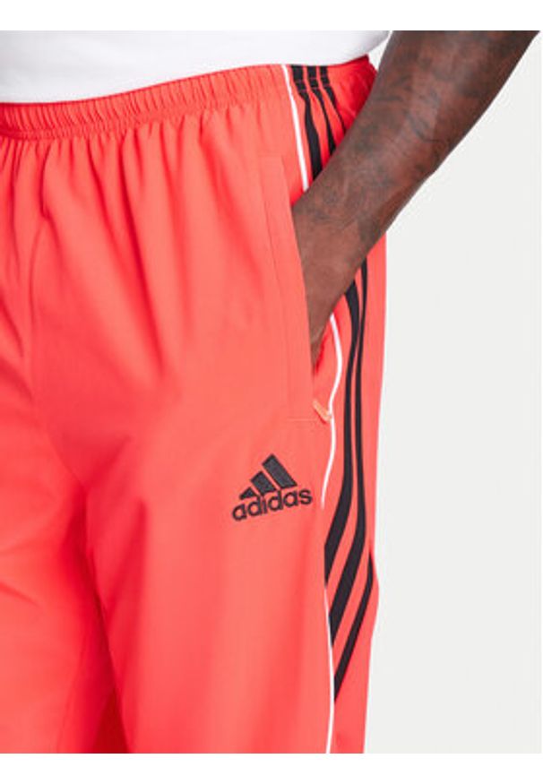 Adidas - adidas Spodnie dresowe Teamgeist adicolor JW5871 Czerwony Loose Fit. Kolor: czerwony. Materiał: syntetyk