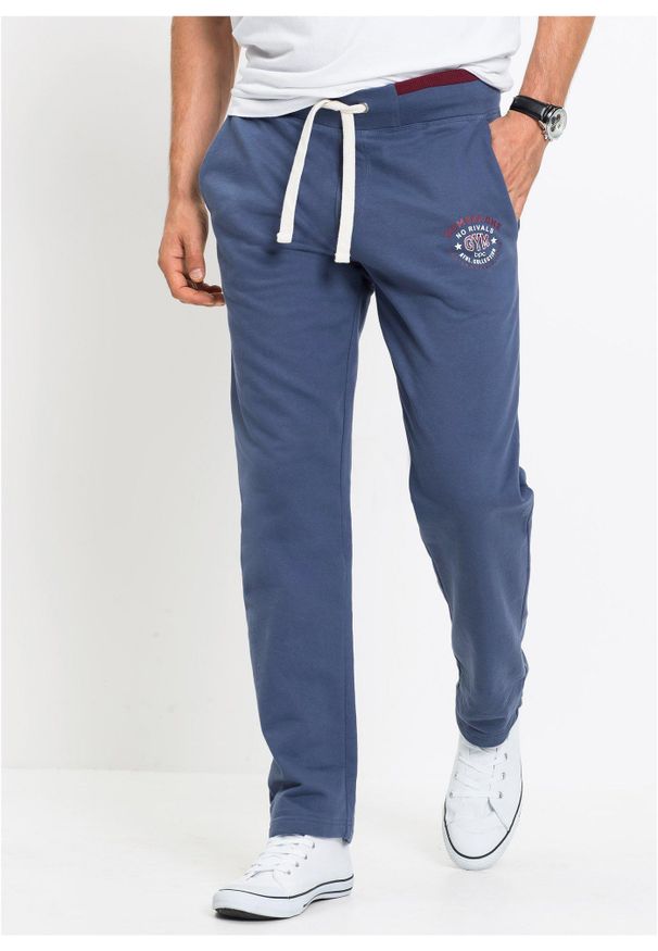 bonprix - Spodnie sportowe z czystej bawełny, ze sportowymi detalami. Kolor: niebieski. Materiał: bawełna. Wzór: nadruk. Styl: sportowy