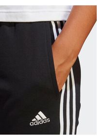 Adidas - adidas Spodnie dresowe Essentials 3-Stripes French Terry Cuffed Joggers IC8770 Czarny Slim Fit. Kolor: czarny. Materiał: bawełna #7