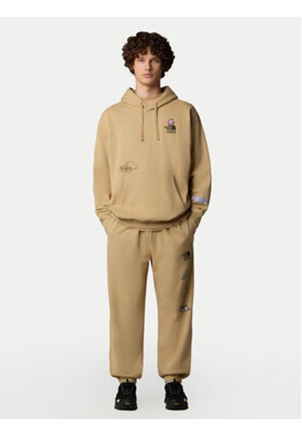 The North Face Spodnie dresowe Unisex Mountain Cleanup NF0A8C2W Beżowy Relaxed Fit. Kolor: beżowy. Materiał: bawełna