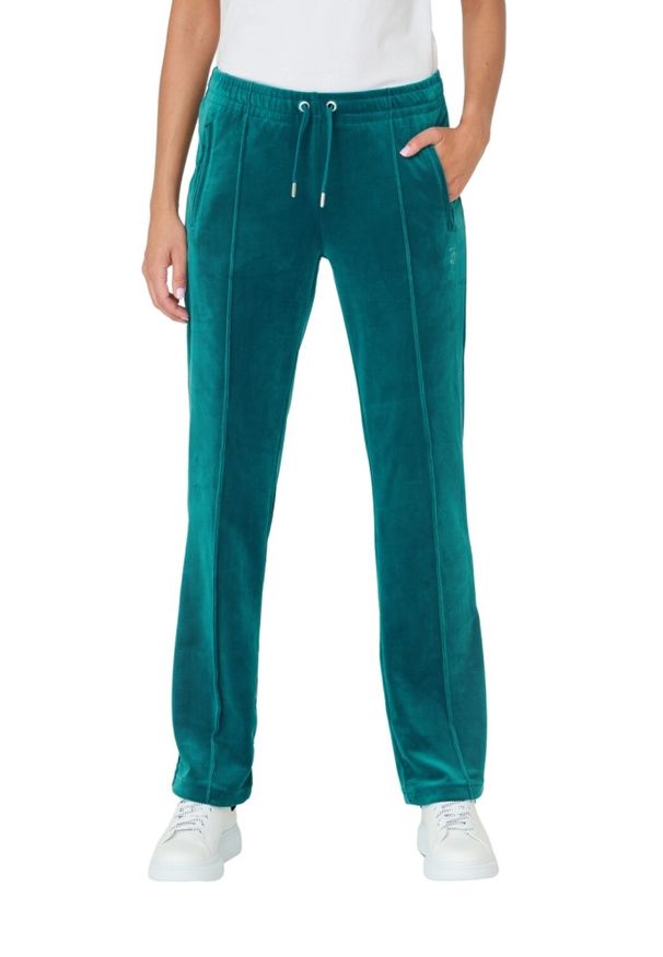 Juicy Couture - JUICY COUTURE Turkusowe spodnie Tina. Kolor: niebieski. Materiał: poliester. Wzór: aplikacja