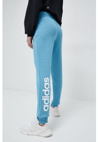 Adidas - adidas spodnie dresowe bawełniane kolor niebieski z nadrukiem. Kolor: niebieski. Materiał: bawełna, dresówka. Wzór: nadruk #3