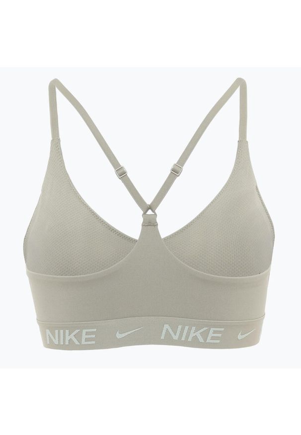 Biustonosz treningowy Nike Dri-Fit Indy Light Support. Kolor: beżowy. Technologia: Dri-Fit (Nike)
