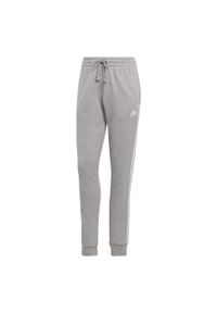 Adidas - Essentials 3-Stripes French Terry Cuffed Pants. Kolor: szary, biały, wielokolorowy. Materiał: materiał. Sport: fitness
