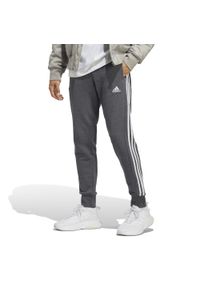 Adidas - Spodnie męskie adidas Essentials French Terry Tapered Cuff 3-Stripes. Kolor: biały, szary, wielokolorowy. Sport: fitness
