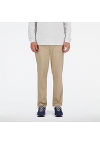Spodnie męskie New Balance MP41575SOT – beżowe. Kolor: beżowy. Materiał: bawełna, nylon