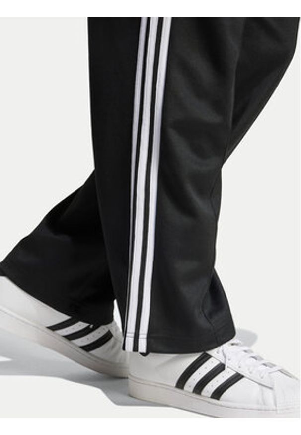 Adidas - adidas Spodnie dresowe adicolor Firebird IZ4801 Czarny Baggy Fit. Kolor: czarny. Materiał: bawełna, syntetyk