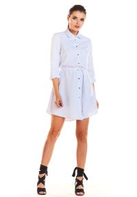 Sukienki.shop - Sukienka koszulowa szmizjerka z asymetrycznym dołem biała. Okazja: na co dzień, do pracy. Kolor: biały, beżowy. Typ sukienki: szmizjerki, asymetryczne, koszulowe. Styl: casual #1