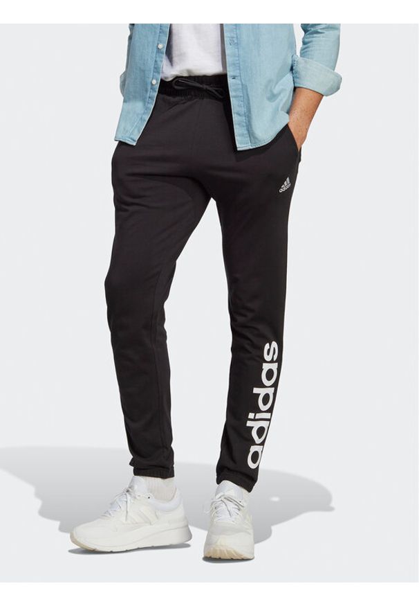 Adidas - adidas Spodnie dresowe Essentials Single Jersey Tapered Elasticized Cuff Logo Joggers IC0055 Czarny Regular Fit. Kolor: czarny. Materiał: bawełna