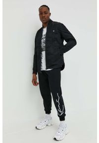 Karl Kani spodnie dresowe kolor czarny z aplikacją 6004039-black. Kolor: czarny. Materiał: dresówka. Wzór: aplikacja #4