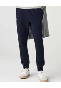 Lacoste - LACOSTE - Granatowe spodnie dresowe Sport Tennis. Kolor: niebieski. Materiał: dresówka. Wzór: haft