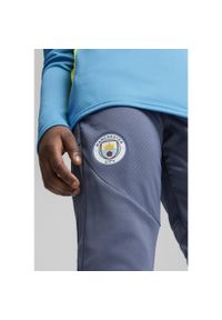 Puma - Młodzieżowe spodnie treningowe Manchester City PUMA Inky Blue Magic. Kolor: niebieski