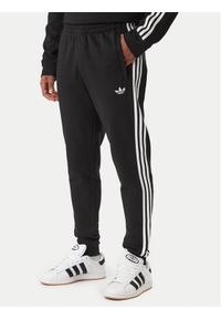 Adidas - adidas Spodnie dresowe 3-Stripes KE3562 Czarny Slim Fit. Kolor: czarny. Materiał: syntetyk, bawełna #1