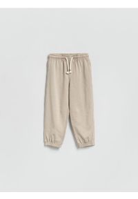 Reserved - Dresowe spodnie z efektem sprania - beżowy. Kolor: beżowy. Materiał: dresówka #1