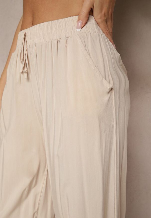 Renee - Beżowe Spodnie z Wiskozy High Waist o Szerokim Kroju Avelozi. Okazja: na co dzień. Stan: podwyższony. Kolor: beżowy. Materiał: wiskoza. Styl: elegancki, casual