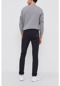 Emporio Armani spodnie męskie kolor granatowy dopasowane. Kolor: niebieski. Materiał: tkanina. Wzór: gładki #4
