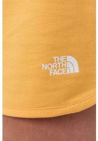 The North Face Szorty Street damskie kolor żółty gładkie medium waist. Kolor: żółty. Materiał: dzianina. Wzór: gładki. Styl: street
