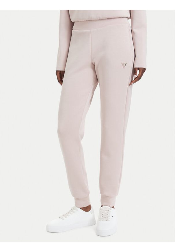 Guess Spodnie dresowe V4YB08 KCAY2 Różowy jasny Regular Fit. Kolor: różowy. Materiał: syntetyk
