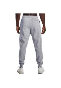 Spodnie sportowe męskie Under Armour Rival. Kolor: szary. Materiał: dresówka. Styl: sportowy. Sport: piłka nożna