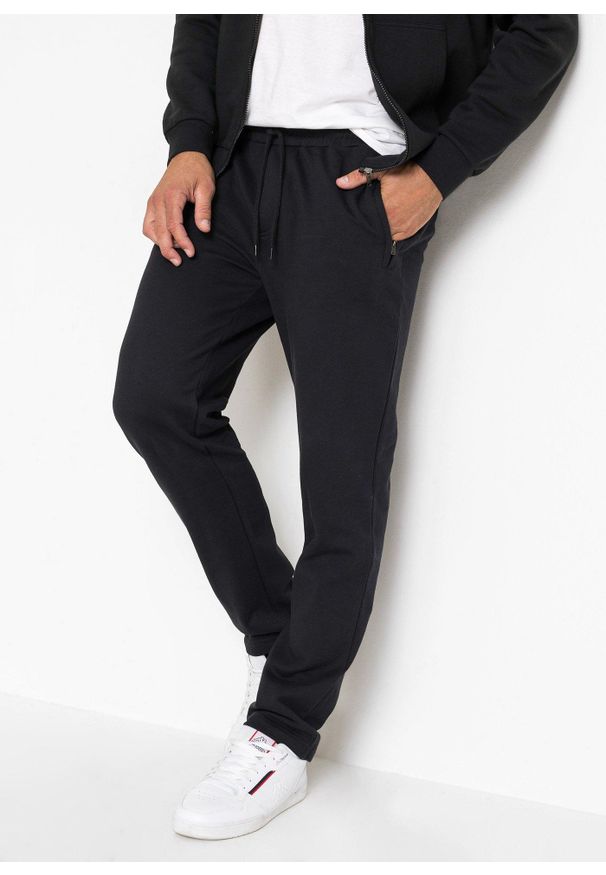 bonprix - Spodnie do biegania z praktycznymi kieszeniami zapinanymi na zamek. Kolor: czarny. Styl: sportowy