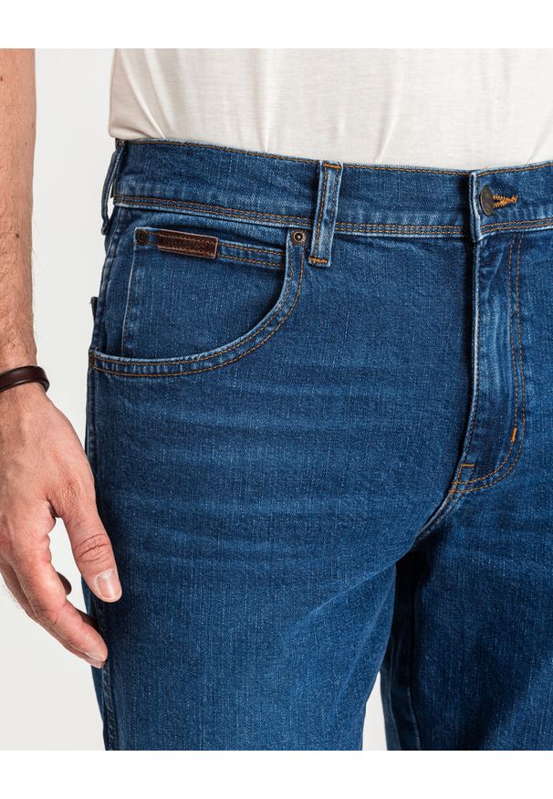 Wrangler - MĘSKIE SPODNIE JEANSOWE WRANGLER TEXAS SLIM GAME ON W12ST112E 112126517. Długość: krótkie. Wzór: jednolity, aplikacja, napisy. Sezon: lato. Styl: klasyczny, retro