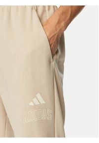 Adidas - adidas Spodnie dresowe Seasonal Essentials Collegiate French Terry Cuffed KF4265 Beżowy Regular Fit. Kolor: beżowy. Materiał: bawełna #2
