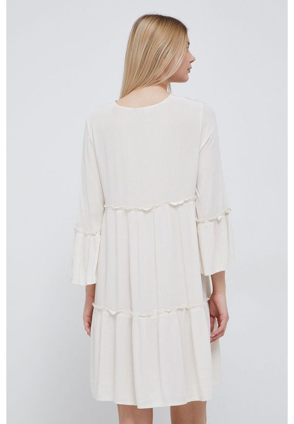 Vero Moda sukienka kolor beżowy mini rozkloszowana. Kolor: beżowy. Materiał: włókno, materiał, tkanina. Wzór: haft. Typ sukienki: rozkloszowane. Długość: mini